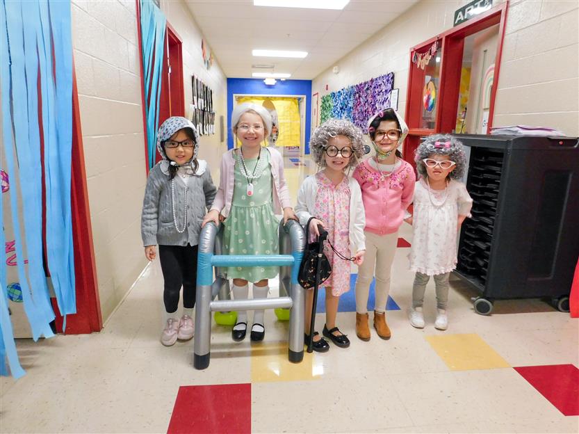 group of girls dressed as 100 year olds in the hallway
